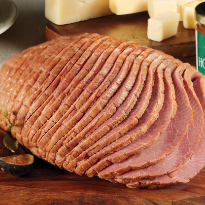 Boneless spiral sliced ham on a wooden tray