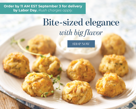 A plate of golden-brown bite-sized crab cake muffins with a small white dipping sauce, overlaid with promotional text reading 'Bite-sized elegance with big flavor,' a 'SHOP NOW' button, and delivery order details that read Order by 11am on September 3 for delivery by Labor Day.